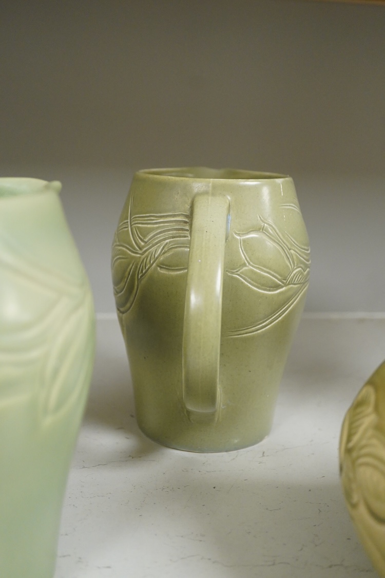 Three Susie Cooper green floral incised jugs, signed to the bases, tallest 16cm high